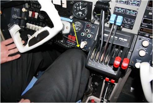 A hydraulic mechanic greasing the landing gear of a transp…